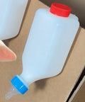 Heavy Duty Lamb Feeding Bottle With Super Soft Nipple For Chill Weaning And Straight Up Nutrition Tracking clutch with blue and red cap.