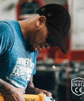 Man wearing Workhorse Lightweight Safety Bump Cap With Removable ABS Insert For Men And Women Baseball Style Head Protection Hat.