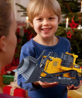 Child holding 11 Channel Remote Control Bulldozer Toy With Lights And Sound 1/16 Scale Front Loader Dozer 2.4GHz RC Vehicle