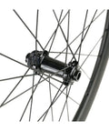 Close-up of the hub and spokes on a 50mm Carbon Wheelset For 700c Road Bikes With Disc Brakes Tubeless Ready Clinchers Built From Toray T700 Carbon Fiber MT075 Hub 24 Spokes Shimano 11 Speed Compatible And Ready To Roll.