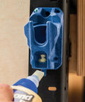 Upside Down Glue Bottle Dock Station With One Handed Access for 4oz, 8oz, 16oz bottles on wall with glue bottle using built-in opener