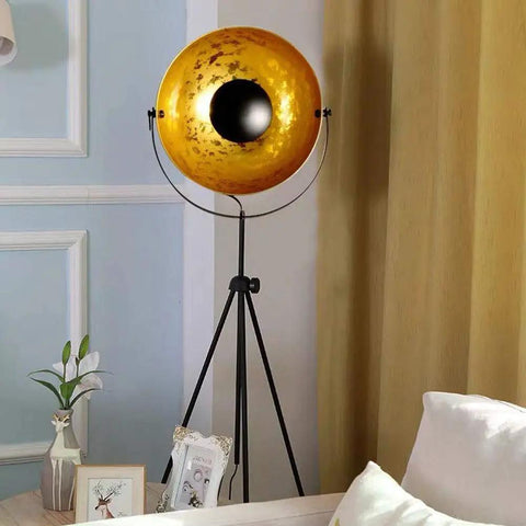 Vintage Industrial Tripod Floor Lamp With LED Light, Large Shade, Matte Black Gold Finish, in living room setting