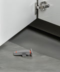 Heavy Duty Cabinet Door Push Latch 2 Pack with adjustable rebound tension placed beneath open cabinet door in kitchen