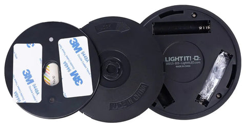 Back view of 9-LED Anywhere Light XB Black 3 Pack with adhesive strips and battery compartment