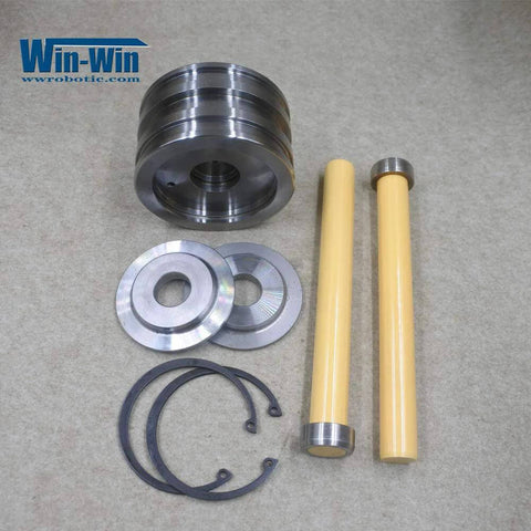 Waterjet piston assembly kit for intensifier pump; includes piston housing, two yellow rods, metal washers, and O-rings.