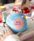 Date Night Special Edition Air Dry Clay Kit For Adults With Tools Paints Brushes Sealant And How To Guides Beginner Friendly DIY Pottery Kit For Home Craft And Relaxing Creative Sessions image showing hand painting a blue clay pot labeled 'Mon Cheri'