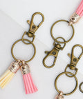60 Pack Bronze Swivel Clasps Featuring Lanyard Snap Hooks With Key Rings Plus Lobster Claw Clips For Jewelry Making And Diy Crafts Hella Durable Zinc Alloy Construction Smooth 360 Spin Action Badass Quality That Lasts, showing details of clips with tassels.