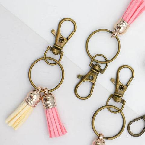 60 Pack Bronze Swivel Clasps Featuring Lanyard Snap Hooks With Key Rings Plus Lobster Claw Clips For Jewelry Making And Diy Crafts Hella Durable Zinc Alloy Construction Smooth 360 Spin Action Badass Quality That Lasts, showing details of clips with tassels.