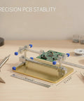 Versatile PCB Soldering Clamp For 3mm To 8mm Boards Gold Finish Stainless Steel Bench Fixture That Holds Circuit Boards Steady Handy Keeping Both Hands Free For Precise DIY Electronics Assembly holding a PCB on a workbench.