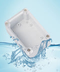 Clear See Through Outdoor Junction Box IP67 Waterproof ABS Plastic Enclosure For Electrical Projects All Weather Ready 68 By 58 By 33 Millimeters Weatherproof Connection Box With Clear Cover And Gray Housing, top view in water