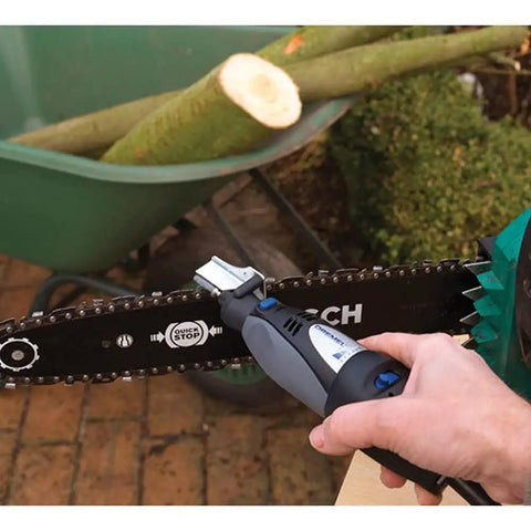 Using the Six Piece Chainsaw Sharpening Attachment Kit For Dremel 1453 Chains on a chainsaw in a garden setting.