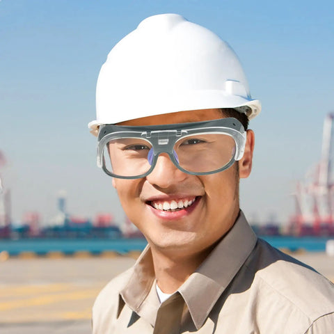 Built Different Welding Safety Goggles With Top Shelf Impact Resistance And Dust Splash Proof Black Gray Lenses For Heavy Duty Shop Work and Everyday Welder Gear worn by smiling worker.