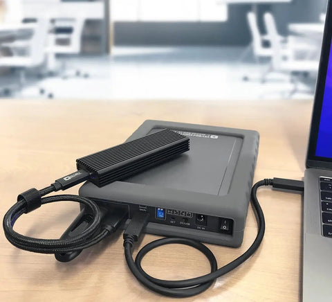 Kickass Dual Bay USB C Enclosure For Two Point Five Inch SATA Drives Featuring Straight Up RAID Setup And Lightning Quick 10Gbps Transfers For Hassle Free Data Storage On The Fly connected to a laptop.