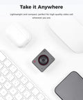 Next Level 4K USB Camera For PC With Plug And Play Setup, compact design on a desk with keyboard and accessories.