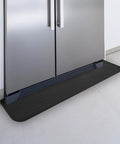 Heavy Duty Fridge Drip Pan And Leak Catcher Mat To Shield Floors From Watery Messes And Keep Your Place Bone Dry Non Slip Silicone Appliance Mat For Washer Or Freezer In Tough Black placed under refrigerator.