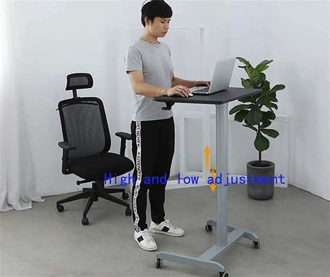 Height Adjustable Mobile Standing Desk With Smooth Roll Wheels Built Tough Rust Resistant Steel Laptop Lectern Workstation Spacious Matte Black Surface No Extra Fluff Office Or Home Setup in use by a man