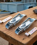 Rock Solid Utility Trailer Lift Gate Latches Two Pack Replacement Handles on a wooden surface, heavy-duty metal construction.