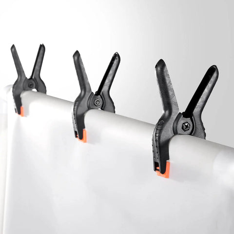 12 Pack 3.5 Inch Heavy Duty Spring Clamps For Crafts And Backdrop Clips gripping white fabric, nylon with fiberglass, 5 lbf grip