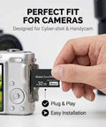 Inserting 32GB Pro Duo Memory Stick Mark 2 into digital camera slot for fast game saves, photos, and video transfers.