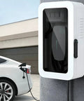 Built Like A Tank Wall Mount Charger Cover With Secure Lock And Cord Organizer For Outdoor Charging Station Box Waterproof Weather Resistant Housing In Classic Black Finish, installed beside a white EV.