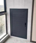 Sleek Aluminum Attic Access Door With Heavy Duty Handle For Zero Hassle Drywall Tuck Away Wall Concealment Hatch Cover In Smooth Gray Solid Pick For Homes Straight Up Durable Build, installed beside a window.