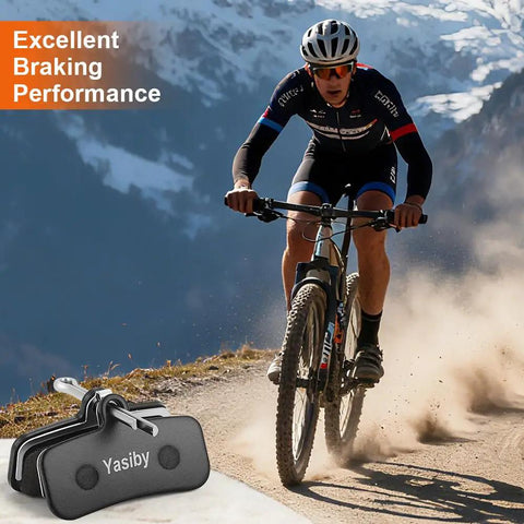 Cyclist brakes on mountain path with High Performance Semi Metallic Disc Brake Pad Set With Installation Tools for Shimano MT420 MT520 M6120 M7120 M8120 and Tektro TRP Ebike Mountain and Road Bikes Beefy Stopping Power 4 Pairs Replacement Pads in foreground