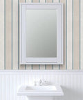 Rustic Victorian Matte Linen Wallpaper, beige wall with narrow blue stripes, bathroom setting with sink and mirror.