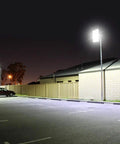 Beastly Bright 300W LED Flood Light with 24000 Lumens outdoor security lighting illuminating a parking lot at night.