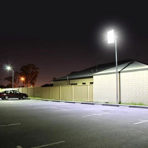 Beastly Bright 300W LED Flood Light with 24000 Lumens outdoor security lighting illuminating a parking lot at night.