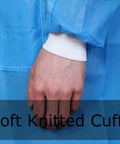 Hand wearing Disposable Lab Coats Pack Of 10 In Blue SMS Polypropylene Anti Static Fluid Resistant with knitted cuffs