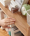 Close-up of Open Style Wooden Bookshelf With Large Capacity Freestanding Storage Organizer showing books and a clock.