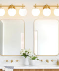 Next Level Three Light Bathroom Vanity Lights In Brushed Gold Finish With Milky White Glass Globe Shades Modern Wall Sconce Over Mirror above double mirrors.