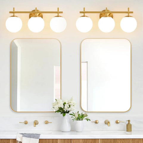 Next Level Three Light Bathroom Vanity Lights In Brushed Gold Finish With Milky White Glass Globe Shades Modern Wall Sconce Over Mirror above double mirrors.