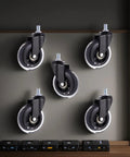 Five Pcs 3 Inch Polyurethane Caster Wheels Silent Rolling Heavy Duty Furniture Casters mounted on wall, showing black wheels and metal stems.