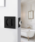 Dope Matte Black Square Pocket Door Lock Kit with Hardware for 2-1/8 Inch Bore installed on white bathroom door