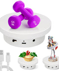 Motorized Rotating Display Stand 5.1 Inch 360 Photography Turntable For Tumbler Jewelry Epoxy Glitter Cup Electric Spinning Platform White Showpiece with purple dumbbells and decorative items.