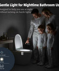 Family using Rechargeable Toilet Night Light With Motion Activated Sensor 16 Color LED Nightlight Inside Bowl in bathroom.