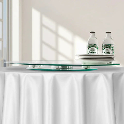 24 Inch Glass Lazy Susan Turntable With 6 Rotating Wheels on dining table with plates and bottles