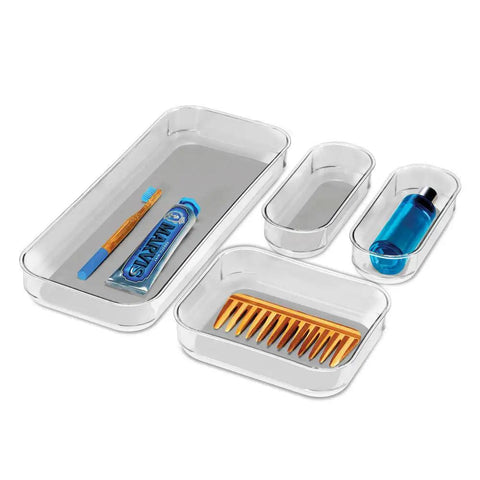 Premium 4 Piece Clear Bin Storage Set For Office, Kitchen, And Home With Soft Grip Lining And Non Slip Base shown with toiletries inside.