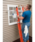 Person painting a window using a Heavy Duty Ladder Stabilizer for 45 Inch Ladders with Quickclick Lock, anti slip feet visible
