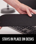 Person holding part of a Silky Memory Foam Wrist Rest For Keyboard And Mouse Ergonomic Design For Typing Pain Relief Two Piece Desk Pad Set Stain Resistant Black Crazy Comfy Fits Most Desks in front of a keyboard.