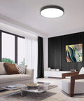 Round Flush Mount LED Ceiling Light 27W 15.7-Inch Black Modern Fixture in a stylish living room with black accents and bright ambiance.
