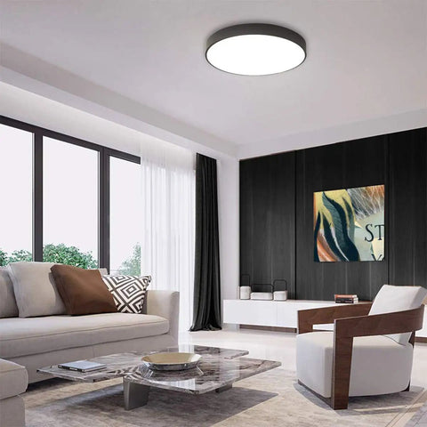 Round Flush Mount LED Ceiling Light 27W 15.7-Inch Black Modern Fixture in a stylish living room with black accents and bright ambiance.