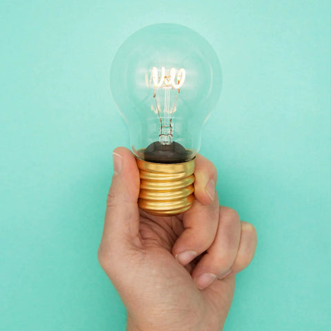 Hand holding Cordless USB Rechargeable LED Light Bulb Lamp With Vintage Edison Glow Portable Bedside Night Light