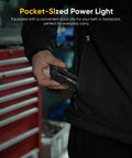 Person holding pocket-sized power light against toolbox in garage