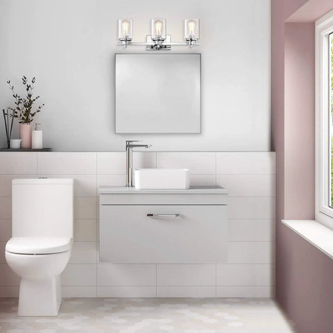 3 Light Chrome Vanity Light Fixtures Over Mirror With Clear Glass Shades in modern bathroom