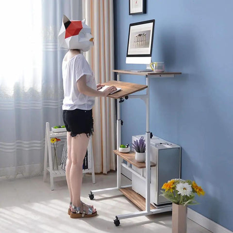 Height Adjustable Overbed Table With Smooth Rolling Casters, Sit To Stand Laptop Desk, Ergonomic Steel Frame Cart For Bed Or Couch, Brown Build Delivers Solid Stability And Hassle Free Mobility For Chill Setups, used by person standing.
