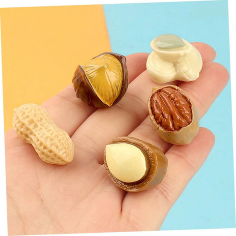 Hand holding Miniature Resin Nut Ornaments Set For Dollhouse Food Decor, Realistic Tiny Nut Models For Crafts And DIY Projects