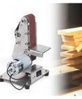 Compact Mini Electric Belt Sander And Polisher For Wood And Metal on a workbench, featuring a stainless steel build for DIY projects.