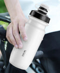 On The Go 550ml Leak Proof Bike Water Bottle With Hands Free Bite Valve held beside a bike